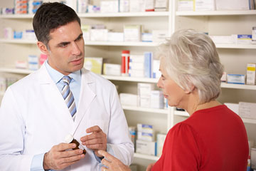 pharmacist conversing with a senior woman