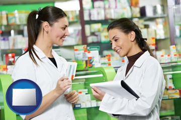 two pharmacists in a drug store - with Colorado icon